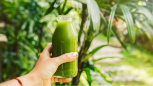 Celery juice bottle being help in field