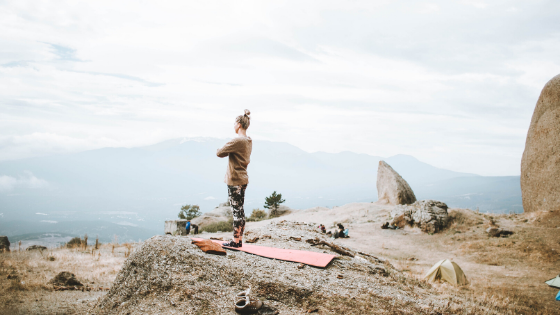 Woman exercising outdoors with yoga mat and chronic fatigue